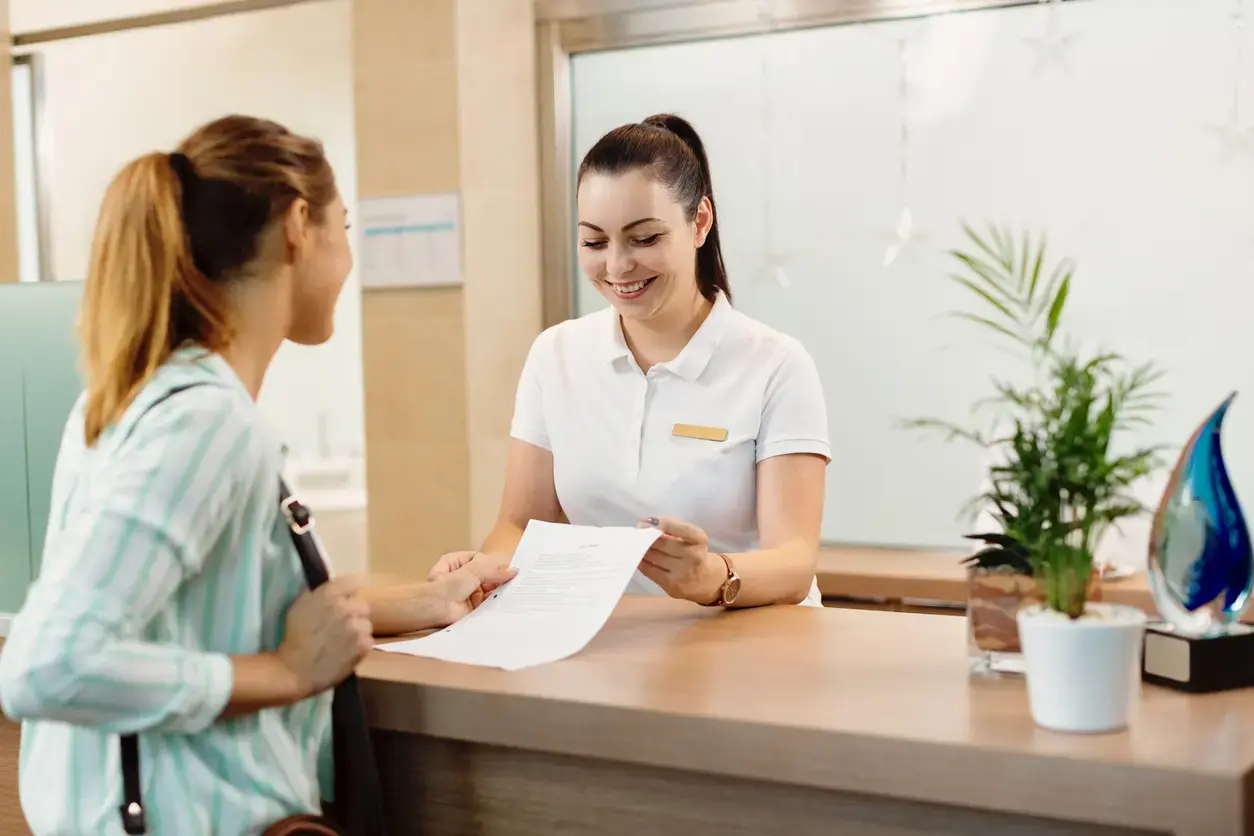 Receptionist at clinic with client